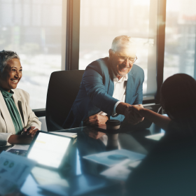 Business personnel coming to an agreement with the help of IBISWorld graphs