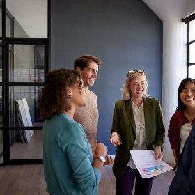 Investment bankers celebrating success with an IBISWorld data sheet